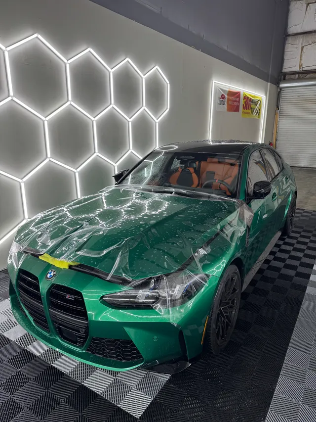 Green BMW M3 having paint protection film fitted to the hood and front bumper in Alpharetta, GA