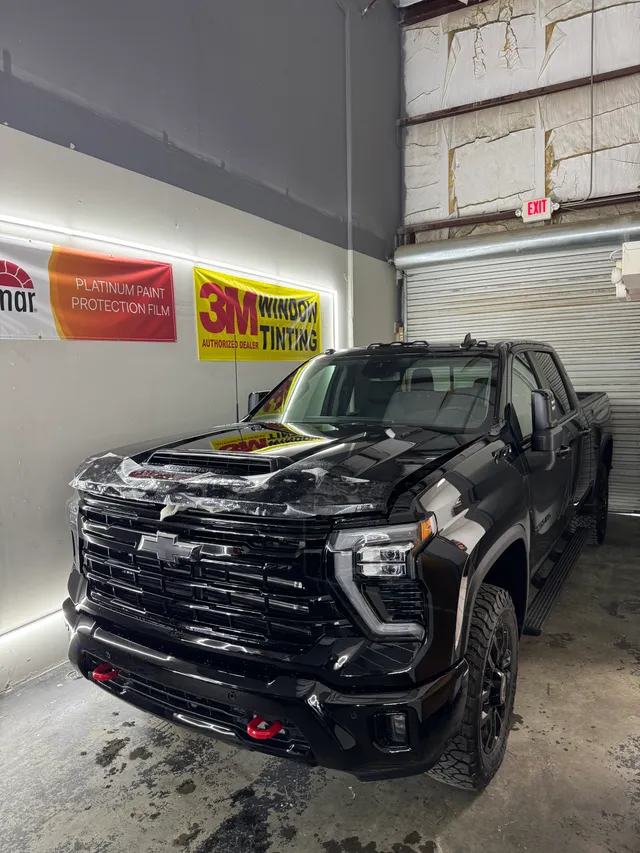 Black Chevrolet Silverado having paint protection film fitted to the hood and front end in Alpharetta, GA