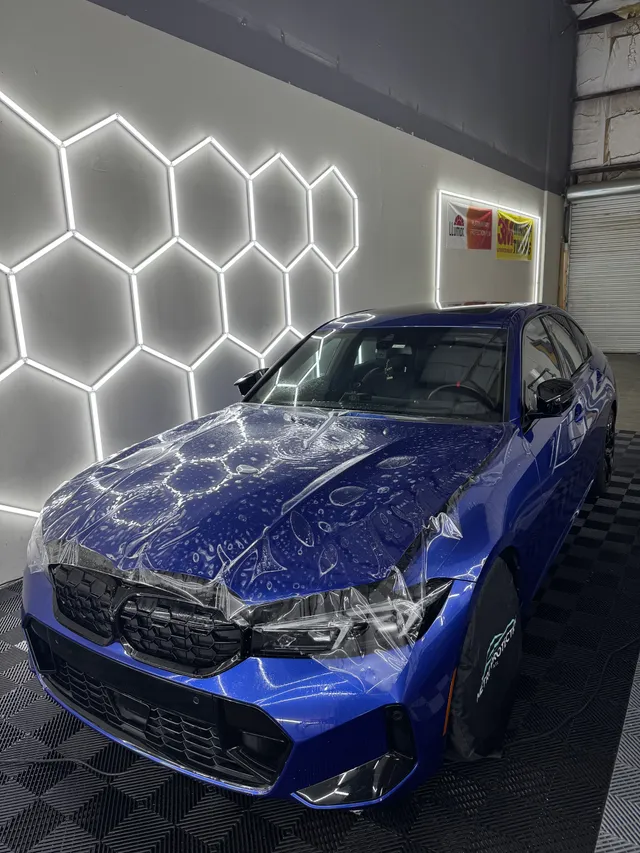 Blue BMW M3 having paint protection film fitted to the hood and front bumper in Alpharetta, GA